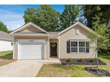 Charming single-story home with a well-manicured front yard and attached garage at 5615 Howard St, Charlotte, NC 28269