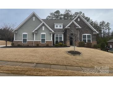 Two-story house with stone and shingle accents, landscaping, and a large front yard at 1336 Stonecrest Blvd, Fort Mill, SC 29708