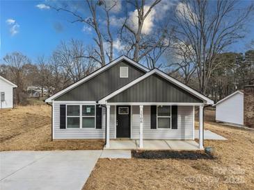 Newly constructed home with gray siding and a welcoming front porch at 1506 Collinston Dr, Gastonia, NC 28052