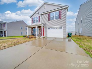 Two-story house with gray siding, red door, and a stone accent at 2643 Idared Dr, Dallas, NC 28034