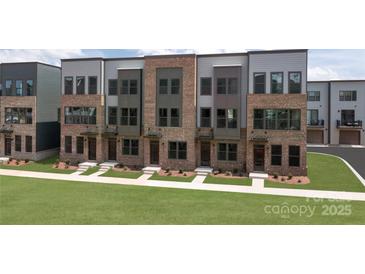 Brick townhouses with modern design, spacious lawn, and ample parking at 3608 Masonboro St # A, Charlotte, NC 28206