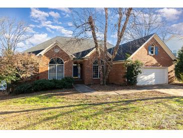 Brick home with attached garage and landscaped lawn at 4907 Foxbriar Trl, Charlotte, NC 28269