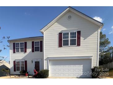 Two-story house with white siding, maroon shutters, and a two-car garage at 5767 Dove Point Dr, Concord, NC 28025