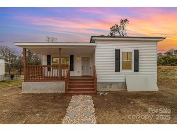 Newly renovated home with a front porch and stone walkway at 6 Walnut St, Great Falls, SC 29055