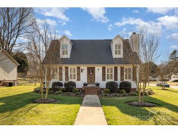 Charming two-story home with dormer windows, shutters, and a well-manicured lawn offers classic curb appeal at 670 Sylvan Sw St, Concord, NC 28025