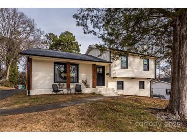 Charming ranch home with white brick facade and updated landscaping at 7445 Briardale Dr, Charlotte, NC 28212