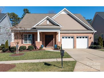 Brick ranch home with two-car garage and landscaped lawn at 14310 Cameryn Elise Dr, Cornelius, NC 28031