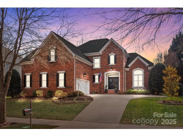 Brick house with landscaped lawn and driveway at 15903 Glen Miro Dr, Huntersville, NC 28078