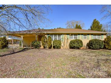 Brick ranch house with covered porch, mature landscaping, and large yard at 194 Bynum Rd, Lincolnton, NC 28092