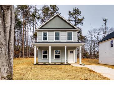 Two-story house with gray siding, white columns, and a front yard at 207 Benfield Rd, Kings Mountain, NC 28086