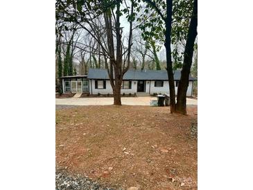 Charming single-story home with a neatly maintained front yard and mature trees offering shade at 217 Ruby Ln, Gastonia, NC 28054