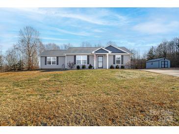 Gray house with a front porch and a large yard at 521 Summer Creek Dr, Stanley, NC 28164