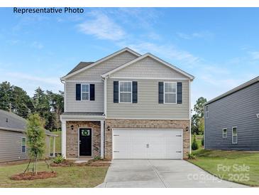 Two-story house with gray siding, brick accents, and a two-car garage at 8068 Plymouth Rd, Sherrills Ford, NC 28673