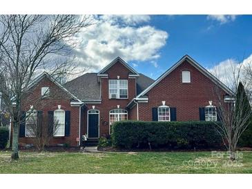 Brick house with landscaped yard and a two-car garage at 1004 Rosewater Ln, Indian Trail, NC 28079