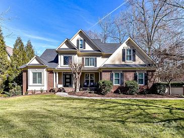 Brick two-story home with a large front yard and mature trees at 10718 Lederer Ave, Charlotte, NC 28277