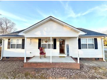 Charming one-story home with front porch and rocking chair at 1105 Mount Olivet Rd, Kannapolis, NC 28083