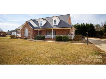 Brick ranch home with stone accents, a large front porch, and a well-manicured lawn at 1270 Mirror Lake Rd, Lincolnton, NC 28092