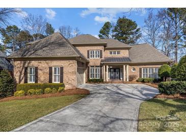 Brick home with a large driveway and landscaping at 15409 Brem Ln, Charlotte, NC 28277