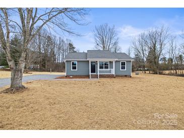 Charming single-story home featuring a cozy front porch, gray siding, and a well-maintained lawn at 368 Luther Scronce Rd, Vale, NC 28168