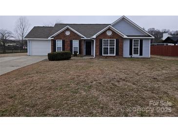 Brick and gray sided home with attached garage and landscaping at 4630 Sw Falcon Chase Sw Dr, Concord, NC 28027