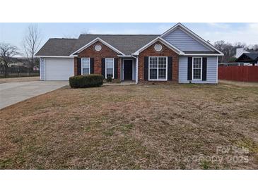 Traditional brick home with a well-maintained front yard and a two-car attached garage at 4630 Sw Falcon Chase Sw Dr, Concord, NC 28027