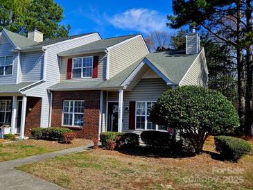 Charming townhome with red shutters, brick accents, and a well-maintained front yard at 10904 Pimlico Dr, Charlotte, NC 28273