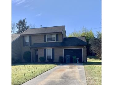 Charming two-story home with a well-manicured lawn and attached garage, perfect for comfortable living at 11306 Kingfisher Dr, Charlotte, NC 28226