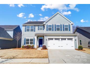 Charming two-story home with a blue front door, shuttered windows, and a two-car garage at 1328 Lena St, Monroe, NC 28112