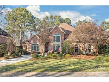 Brick home with landscaped lawn and large driveway at 15214 Mccomb Manor Ct, Charlotte, NC 28277