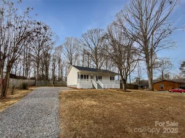 Newly built home with front porch and gravel driveway at 165 Bowman Rd, Statesville, NC 28625