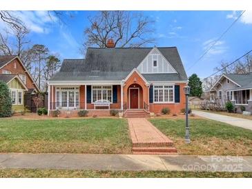 Brick home with a charming front porch and well-manicured lawn at 357 7Th Nw St, Hickory, NC 28601