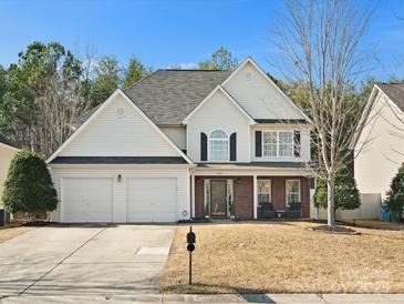 Charming two-story home with manicured lawn, two car garage, and inviting front porch at 3865 Parkers Ferry Rd, Fort Mill, SC 29715