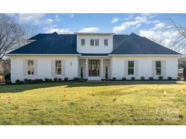 Stunning white brick home with a charming front porch and manicured lawn at 3935 Black Sycamore Dr, Charlotte, NC 28226