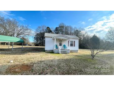 Quaint white house with a covered porch and a spacious yard at 510 W Blume St, Landis, NC 28088