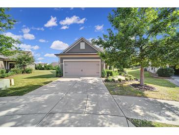 Gray Craftsman style home with attached garage and manicured landscaping at 730 Bushel Dr, Fort Mill, SC 29715