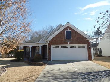 Brick home with two-car garage and landscaped yard at 9018 Kestral Ridge Dr, Charlotte, NC 28269