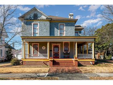 Two-story home with a wrap-around porch and intricate facade at 143 Reid St, Rock Hill, SC 29730