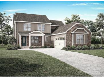 Two-story home exterior featuring stone and siding, two-car garage, and landscaped yard at 1939 Hendricks St, Rock Hill, SC 29732