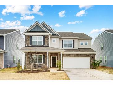 Two-story brick home with attached garage and landscaping at 3594 Cerelia Ln, Denver, NC 28037