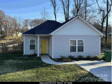 Small gray sided home with yellow door and small lawn at 4470 Kingsbury Rd, Midland, NC 28107