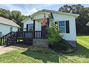 Charming home featuring a cozy front porch with black trim and an American flag at 629 S Caldwell St, Salisbury, NC 28144