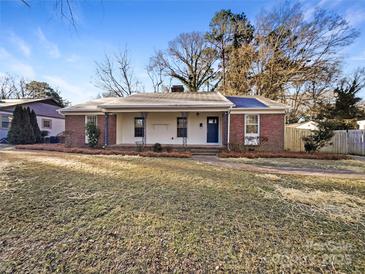Brick ranch house with covered porch and landscaped yard at 1005 Woodland Dr, Gastonia, NC 28054
