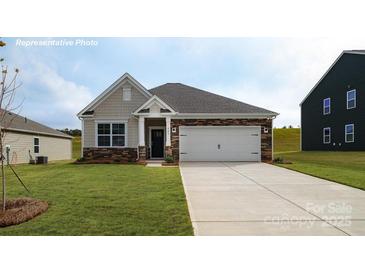 Charming single-story home featuring a two-car garage, stone accents, and a well-manicured lawn at 1400 6Th Ne St, Hickory, NC 28601
