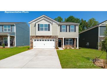 Charming two-story home with stone accents, a two-car garage, and a well-manicured lawn at 1412 6Th Ne St, Hickory, NC 28601