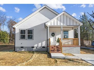 Charming white house with brick steps, wooden porch railing, and landscaping at 109 E Broad St, Salisbury, NC 28144