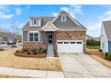 Charming home with a stone and gray siding, complemented by a two-car garage and well-maintained landscaping at 1605 Appledale Ct # 116, Fort Mill, SC 29715