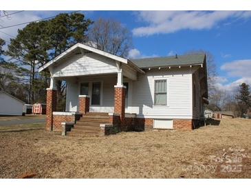 White sided home with brick base and covered porch at 1724 Lowder St, Albemarle, NC 28001