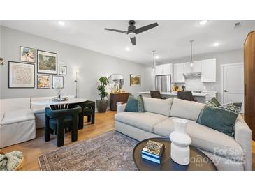 Open living area with modern sofa, dining table, and kitchen views at 203 Grandin Rd # 3, Charlotte, NC 28208