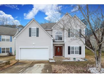 Two-story house with a white garage door and landscaping at 3111 Hendricks Chapel Ln, Charlotte, NC 28216