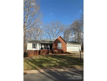 Charming single-Gathering home boasts brick and vinyl siding, a manicured lawn, and a two-car garage at 3605 Truxton Ct, Waxhaw, NC 28173